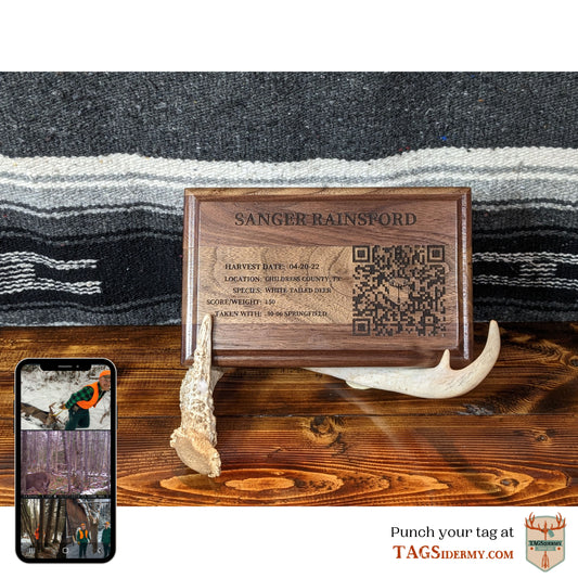 TAGSidermy Trophy Tag Wall Plaque. A wall plaque that links you quickly to your photos and videos from your hunting and outdoor adventures. A QR code and NFC tag to link you to an online photo gallery album. Natural wood plaque to pair with your taxidermy mount.